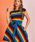 Woman wearing retro rainbow stripe dress with white cat-eye sunglasses and fit and flare silhouette