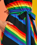 Close-up of rainbow striped dress with sash tie belt, bias stripe waistband, and pocket detail
