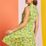 Woman twirling in sleeveless botanical cat print dress with vintage-inspired silhouette