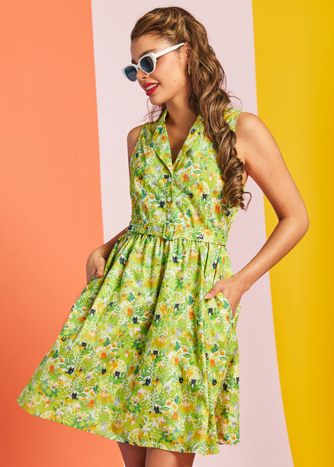 Woman posing in retro cat print cotton dress with belted waist and full skirt