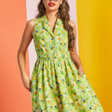 Woman wearing ModCloth sleeveless fit and flare dress in green hidden cat floral print with white cat-eye sunglasses