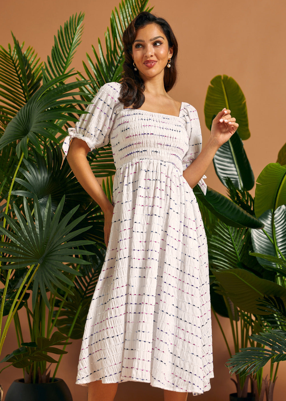 Front view of a white textured midi dress with a smocked bodice, square neckline, and gathered skirt.