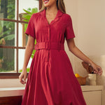 A woman modeling a short-sleeve midi dress in a solid red color.
