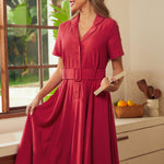 A woman wearing a short-sleeve, collared midi dress in red.