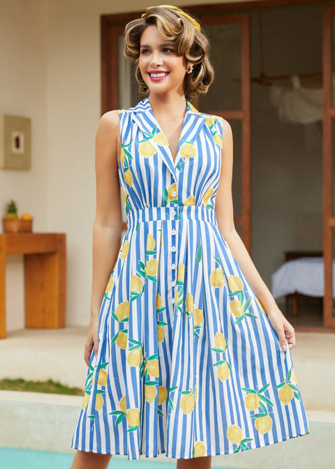 Woman twirling in a sleeveless lemon stripe midi dress with pockets.