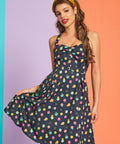 Front view of colorful dotted mini dress with decorative button-front bodice