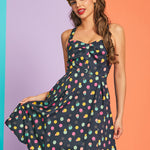 Front view of colorful dotted mini dress with decorative button-front bodice