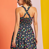 Back view of sleeveless retro mini dress with crossed straps and hidden zipper detail
