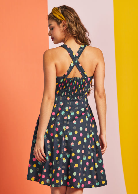 Back view of sleeveless retro mini dress with crossed straps and hidden zipper detail