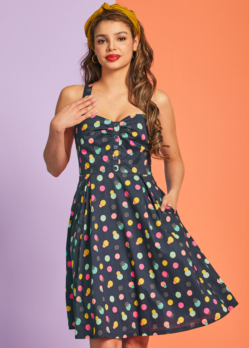 Woman wearing vintage-inspired polka dot mini dress with gathered bust detail and pockets
