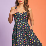 Woman wearing vintage-inspired polka dot mini dress with gathered bust detail and pockets