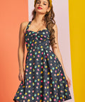 Woman wearing a polka dot party dress with a colorful background
