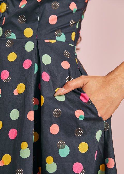 Close-up of colorful polka dot print and functional side pocket on navy cotton dress