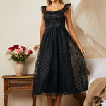 Black tulle fit and flare dress with polka dot mesh overlay and flutter straps, front view