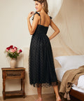 Back view of black tulle midi dress with smocked back and layered skirt