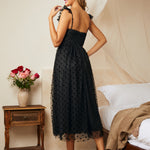 Back view of black tulle midi dress with smocked back and layered skirt