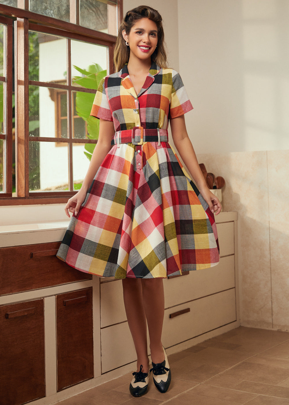 Woman wearing a vintage-inspired wine plaid dress with a full twirl-ready skirt.
