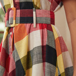 Close-up of the coordinating removable belt and waist detail on the plaid dress.