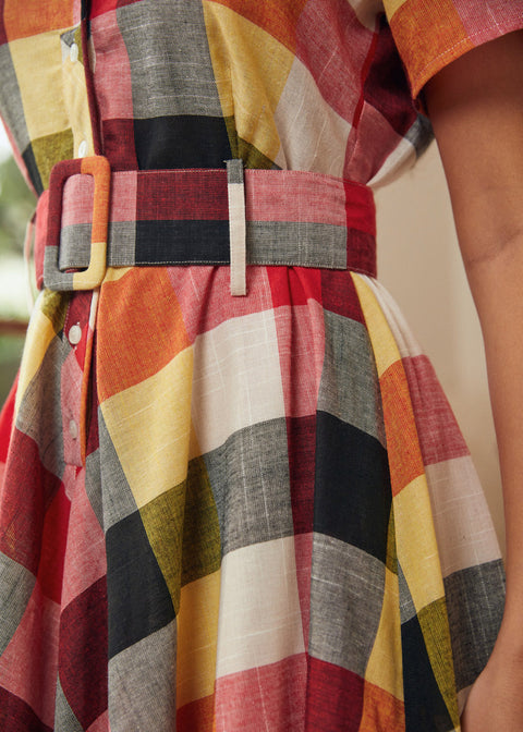 Close-up of the coordinating removable belt and waist detail on the plaid dress.