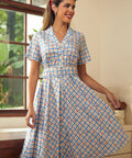 Woman wearing a blue cherry plaid fit-and-flare shirt dress with a removable belt.