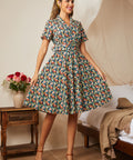 Woman wearing a navy floral fit-and-flare shirt dress with a removable matching belt.