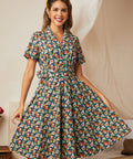 Woman wearing a vintage-inspired midnight floral belted fit-and-flare dress.