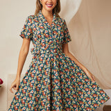 Woman wearing a vintage-inspired midnight floral belted fit-and-flare dress.