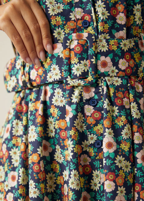 Close-up of the removable fabric belt and button-front bodice on the floral dress.