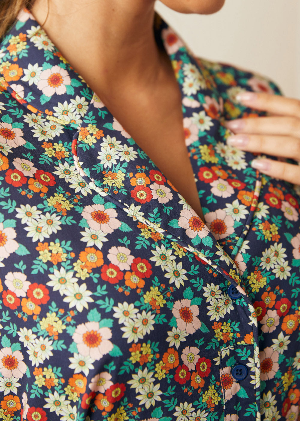 Close-up of the notched collar and colorful vintage floral print on a cotton dress.