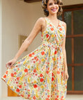 Woman twirling in a retro-inspired floral faux wrap dress with a full skirt and vibrant botanical print.