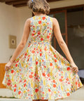 Back view of a vintage-inspired cotton floral dress with an elastic back waist and full skirt.