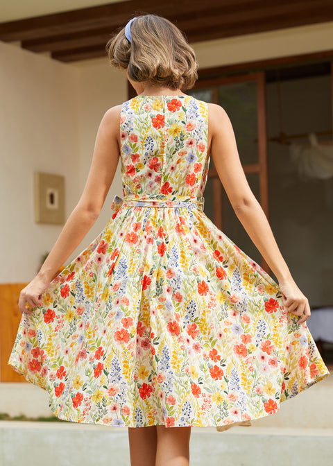 Back view of a vintage-inspired cotton floral dress with an elastic back waist and full skirt.
