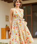 Vintage-inspired cotton dress with a watercolor floral print, side pockets, elastic back waist, and flattering faux wrap silhouette.