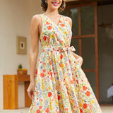 Vintage-inspired cotton dress with a watercolor floral print, side pockets, elastic back waist, and flattering faux wrap silhouette.