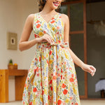Front view of a sleeveless floral faux wrap dress featuring a V-neckline and fit-and-flare silhouette.