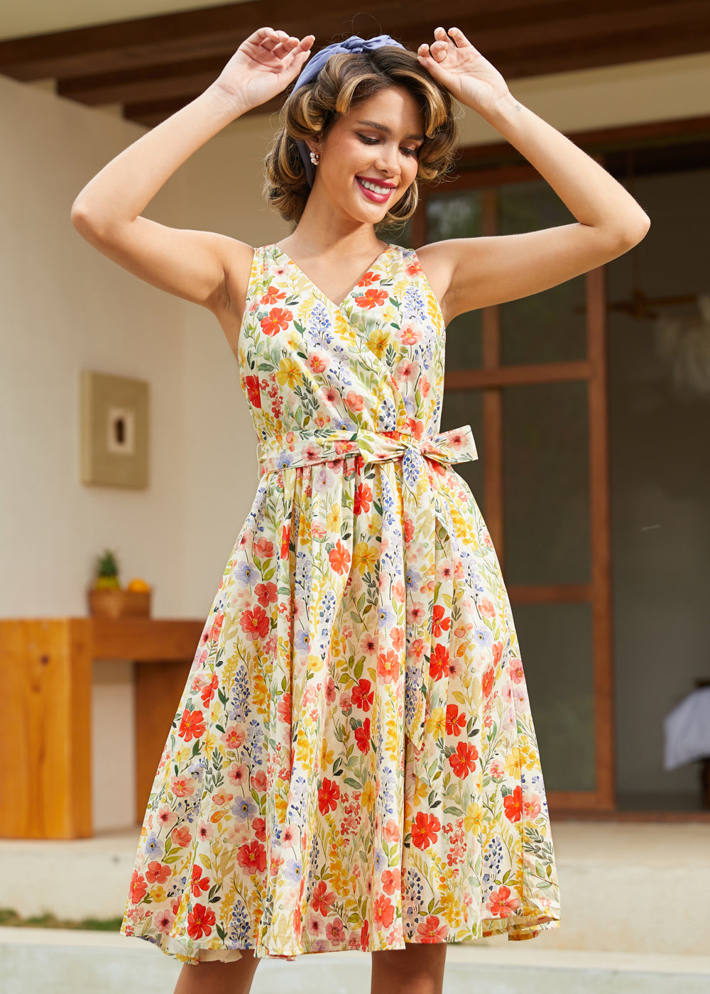 Woman styling a sleeveless fit-and-flare floral dress with a removable sash belt for spring and summer.