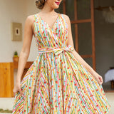 Vintage-inspired sleeveless cotton dress with colorful fruit stripe print, removable sash, back zipper, and side pockets.