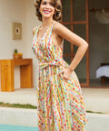 Side view of a vintage-inspired sleeveless cotton dress featuring a novelty fruit stripe print.