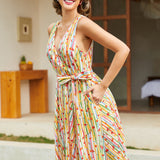 Side view of a vintage-inspired sleeveless cotton dress featuring a novelty fruit stripe print.
