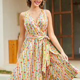 Woman wearing a vintage-inspired faux wrap cotton dress with colorful fruit stripes and a removable tie belt.