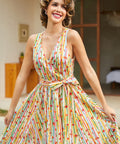 Front view of a retro fit-and-flare dress with colorful fruit stripes, V-neckline, and twirl-worthy skirt.