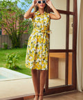 Front view of a retro lemon print shirt dress featuring a collared neckline, button-front, and side pockets.