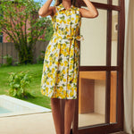 Front view of a retro lemon print shirt dress featuring a collared neckline, button-front, and side pockets.