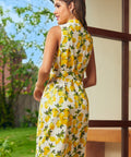 Back view of a sleeveless vintage-inspired dress with an allover lemon print and tailored silhouette.