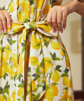 Detail of the removable self-tie waist belt on a lemon print cotton shirt dress.