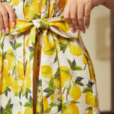 Detail of the removable self-tie waist belt on a lemon print cotton shirt dress.