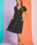 Woman wearing retro cherry print fit-and-flare midi dress with short sleeves