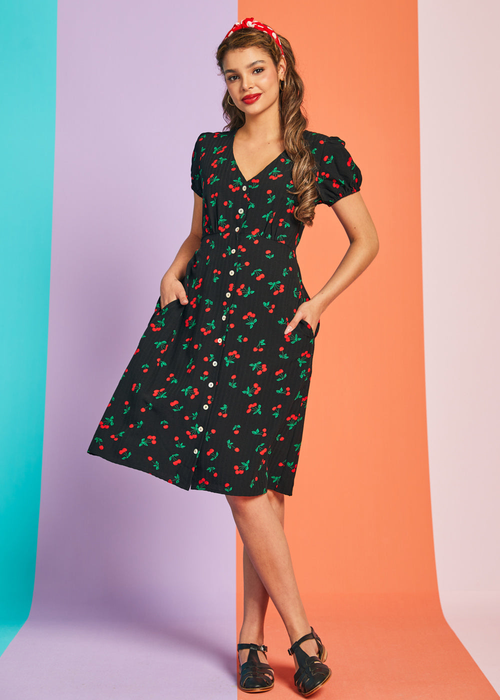 Woman wearing retro cherry print fit-and-flare midi dress with short sleeves