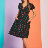 Woman wearing retro cherry print fit-and-flare midi dress with short sleeves