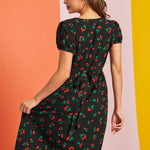 Woman twirling in retro cherry print midi dress with puff sleeves